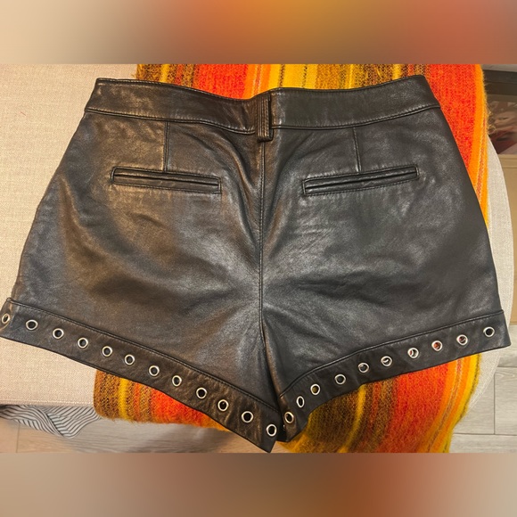 Genuine leather black mini shorts lined with silver metal grommets. Size 8 - Picture 4 of 7
